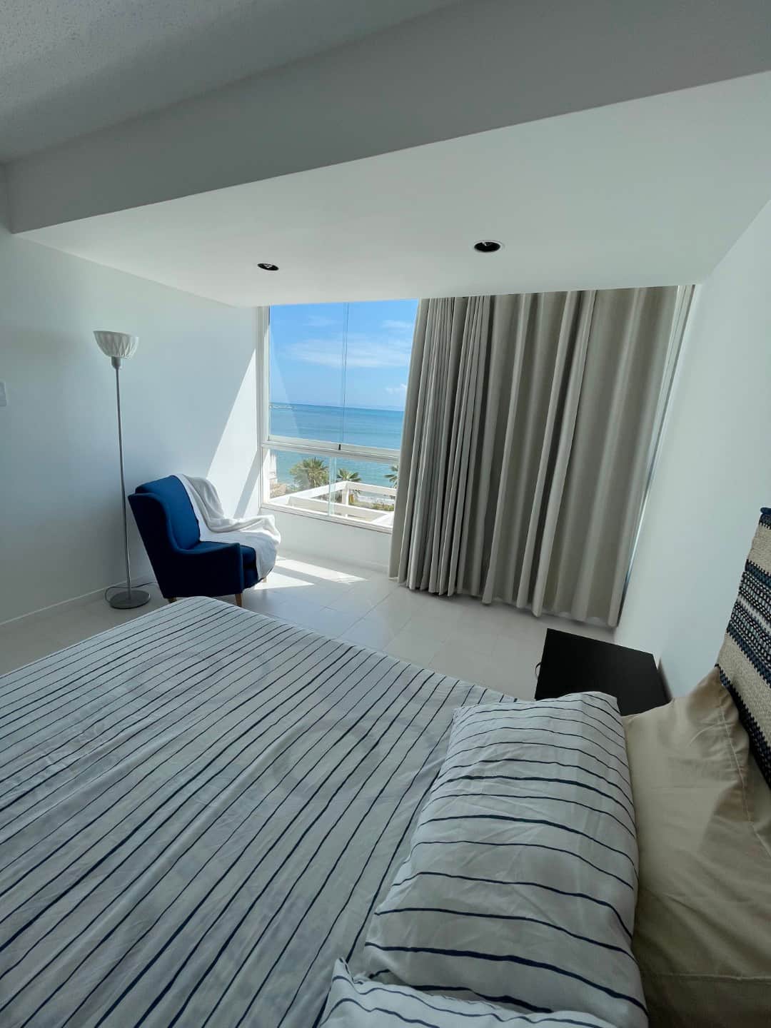 Main bedroom with sea view through large window, blue armchair, Porlamar, Margarita Island